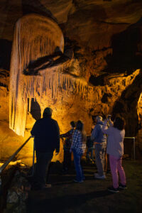 People walking in a cave.