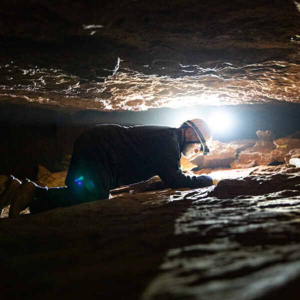 Man spelunking in a cave at Grand Caverns.